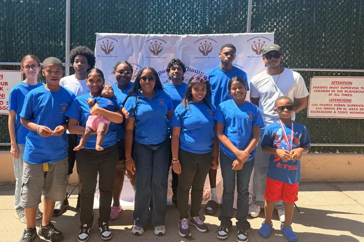 The Compassion Champions team and families together at the 2026 backpack giveaway