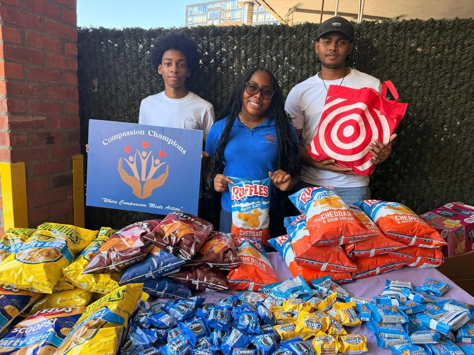 Volunteers with a Target donation and tables of snacks