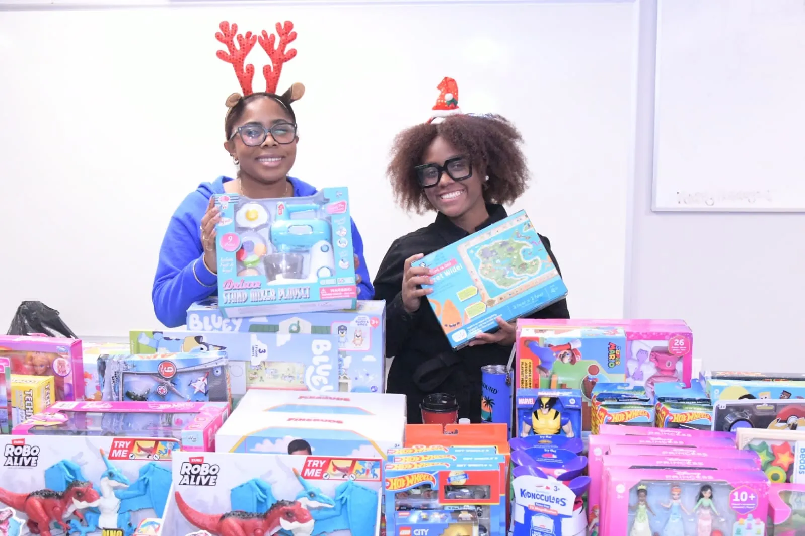 Volunteers with tables full of donated toys